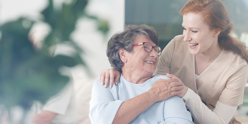 A smiling patient and caregiver.