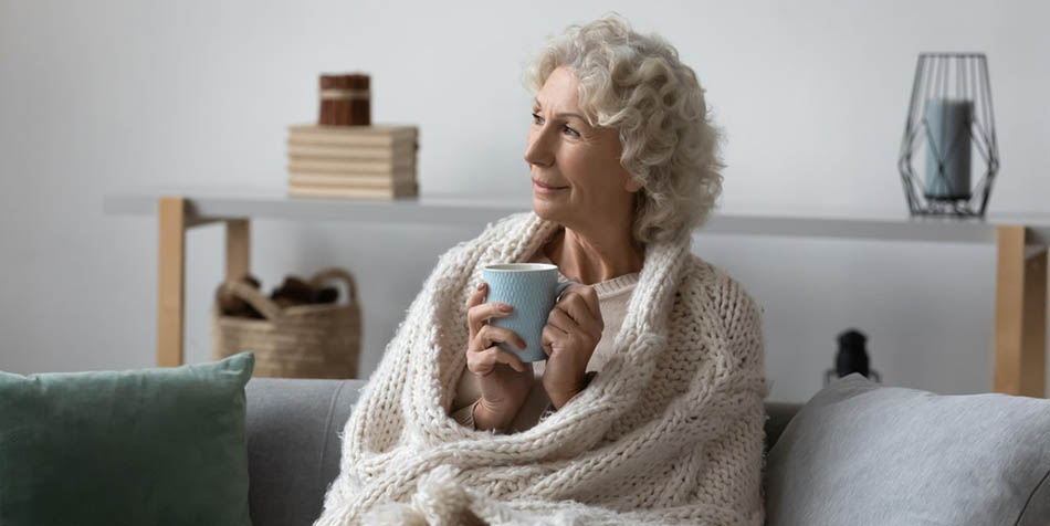 A woman drinks a cup of tea.